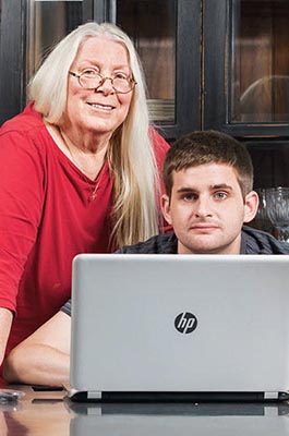 Woman with young man sitting at a computer