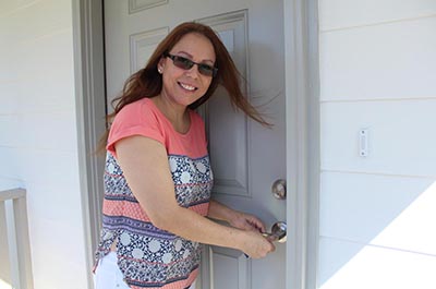 Woman unlocking her front door