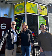 Three adults standing in front of TeaLee’s Tea House and Bookstore
