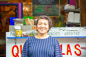 Woman standing in front of her restaurant