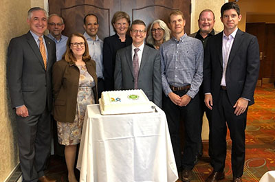 Praxis staff with 25th anniversary cake
